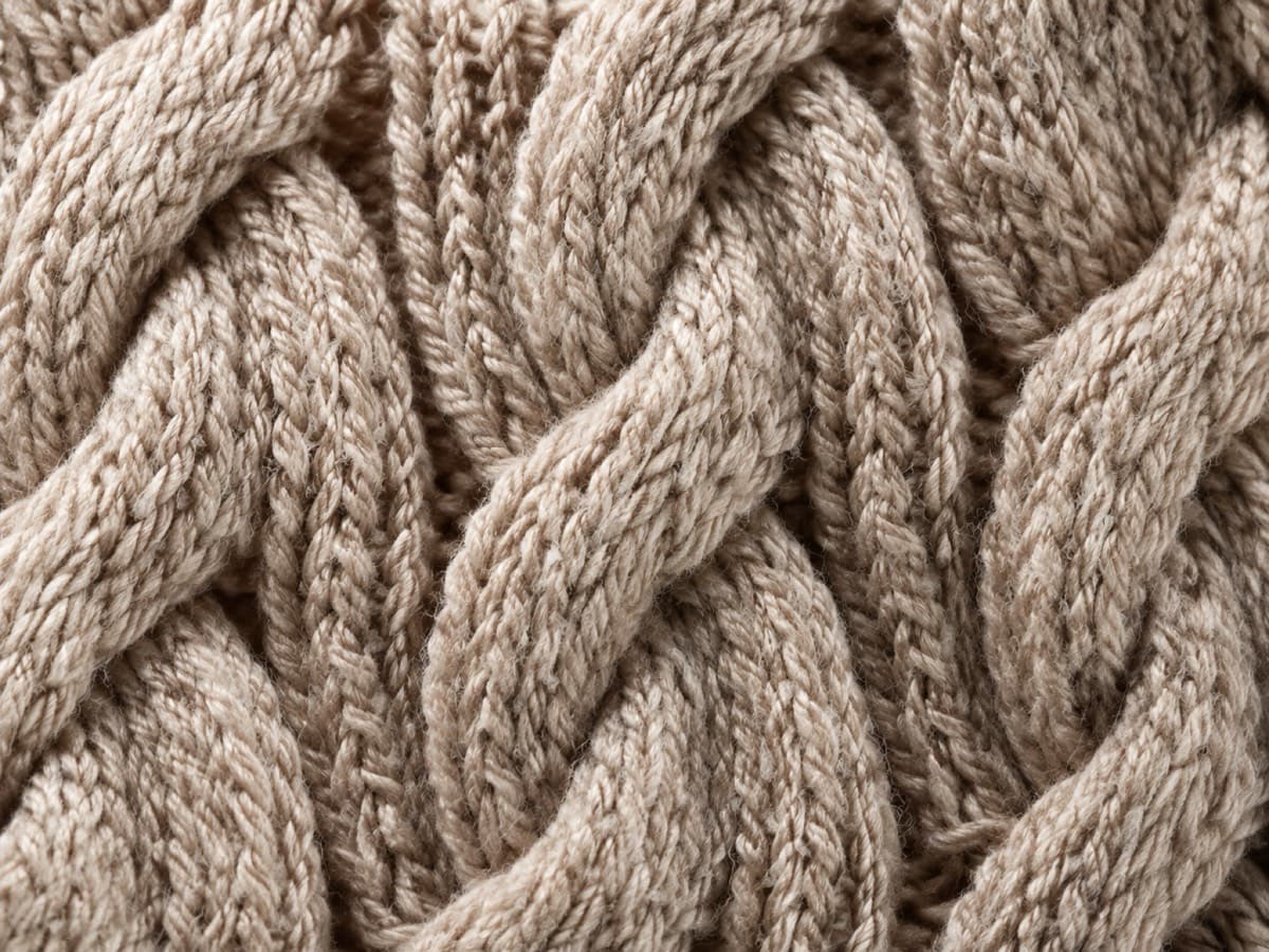 Macro of a six-strand cable, the yarn crossing over itself