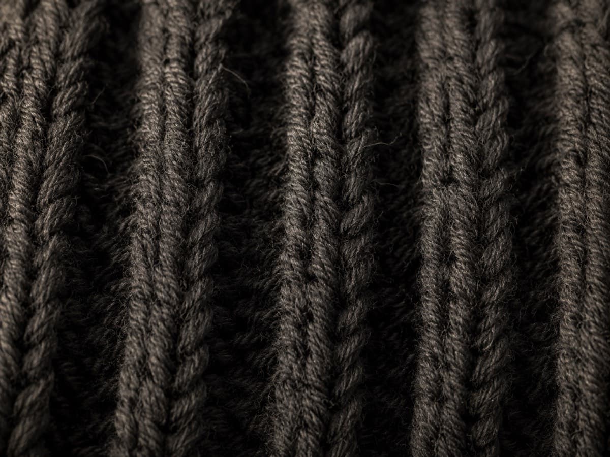 Macro photograph of merino rib knitting with countable stitches